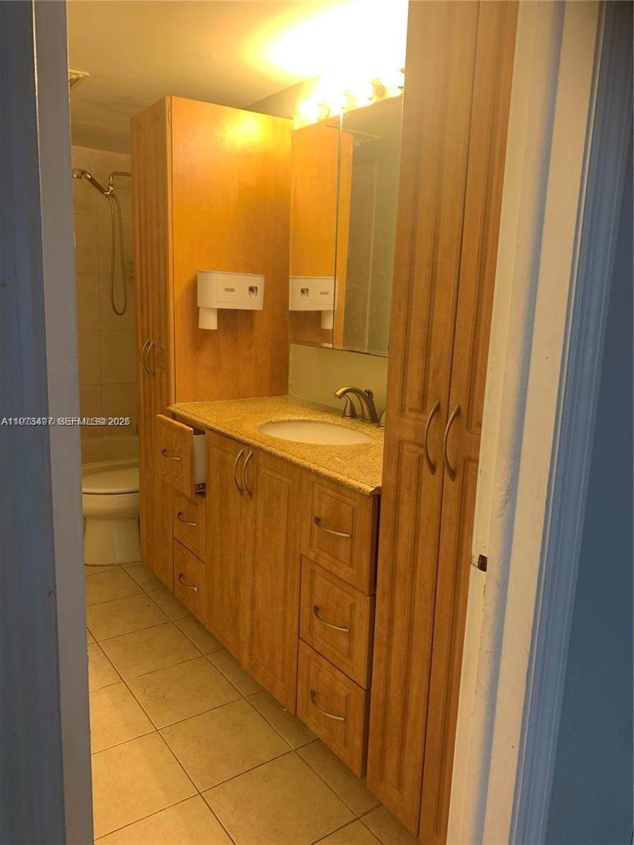 4222 Inverrary Boulevard, Unit 4415 Lauderhill, FL 33319 - Photo 3 of 11 a bathroom with a shower and a sink