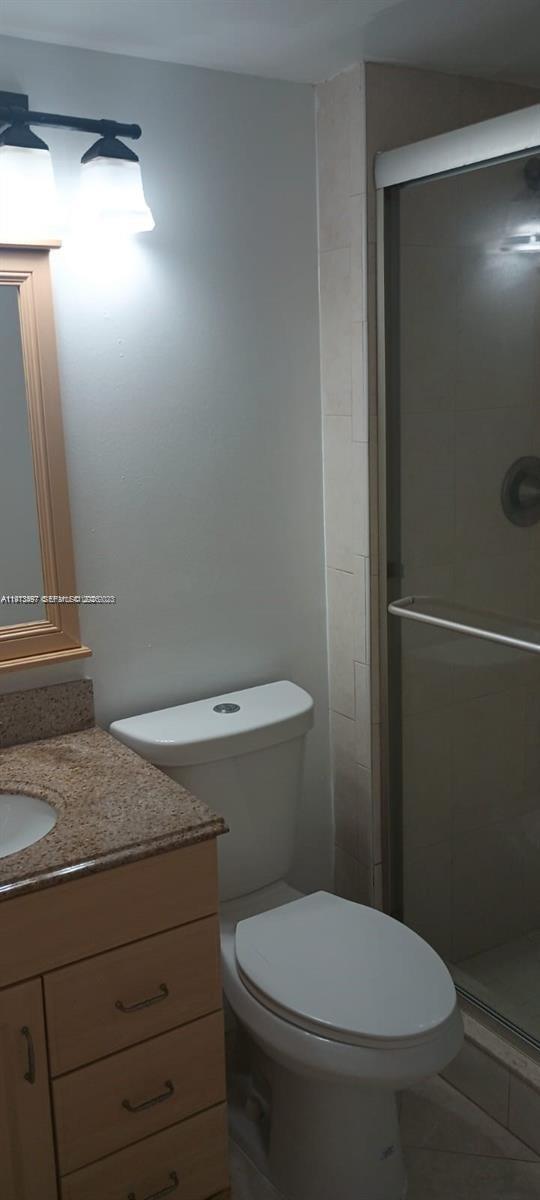 4222 Inverrary Boulevard, Unit 4415 Lauderhill, FL 33319 - Photo 5 of 11 a bathroom with a toilet and a mirror