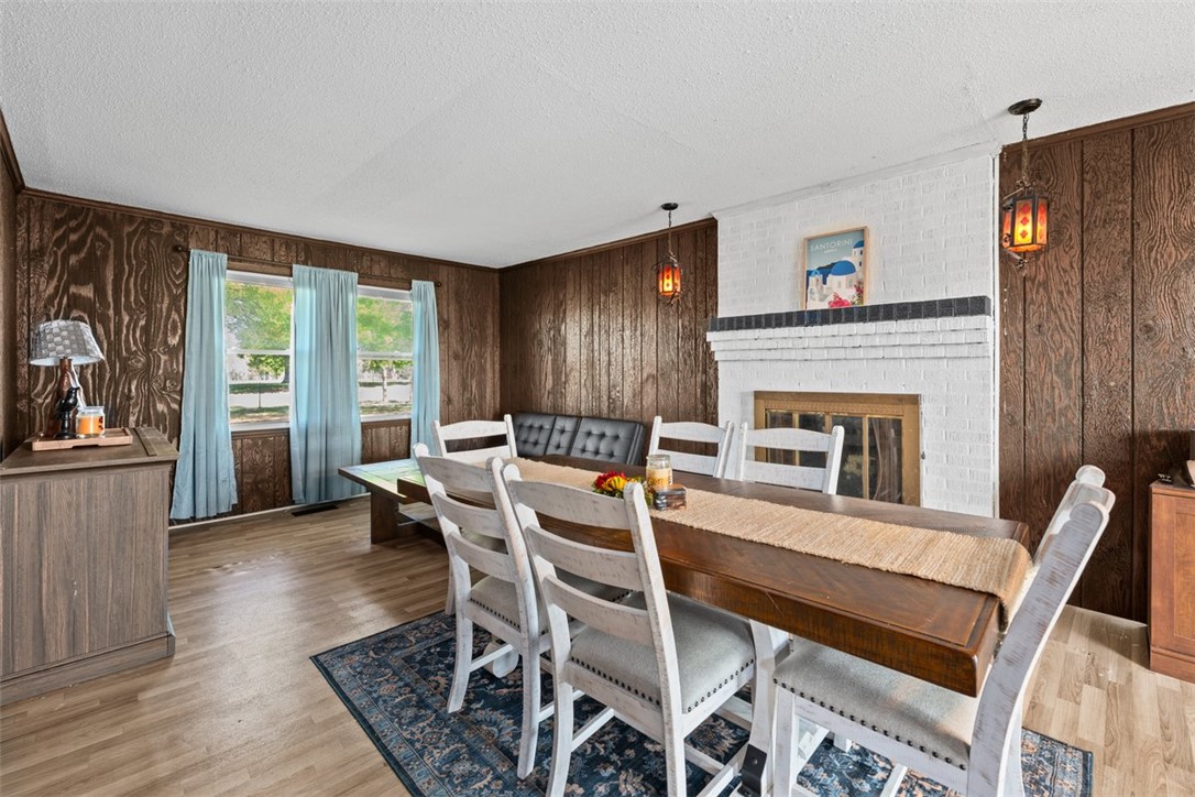606 County Rd S-1-149 Donalds, SC 29638 - Photo 13 of 38 This inviting dining area features a prominent fireplace, perfect for gathering and entertaining.