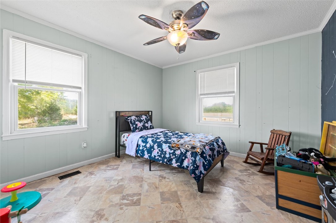 606 County Rd S-1-149 Donalds, SC 29638 - Photo 24 of 38 This cozy bedroom features durable tile flooring, creating a comfortable and inviting atmosphere.