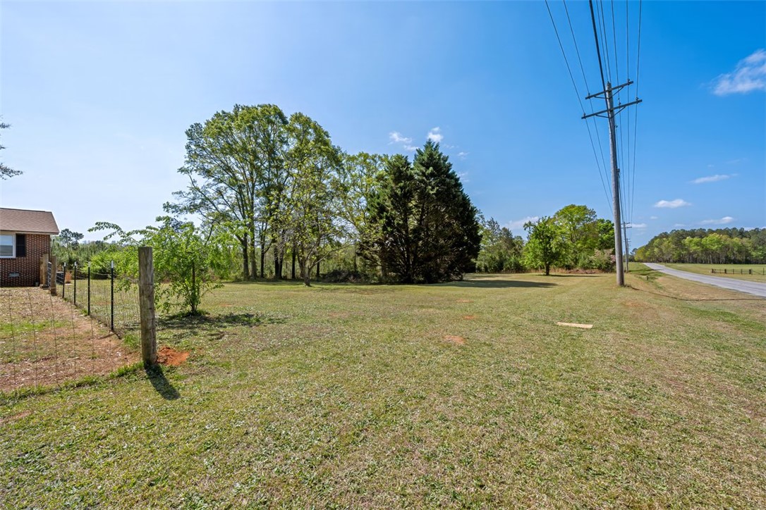 606 County Rd S-1-149 Donalds, SC 29638 - Photo 35 of 38 Expansive green yard with mature trees offers a serene natural setting.