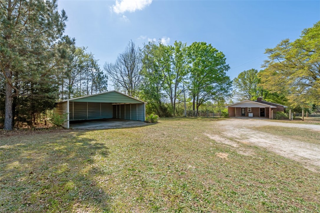606 County Rd S-1-149 Donalds, SC 29638 - Photo 37 of 38 This property features a spacious yard and a detached carport.