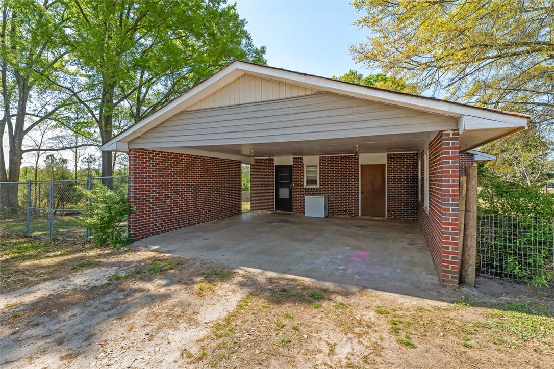 606 County Rd S-1-149 Donalds, SC 29638 - Photo 4 of 38 This residence features a brick exterior and a convenient carport for sheltered parking.