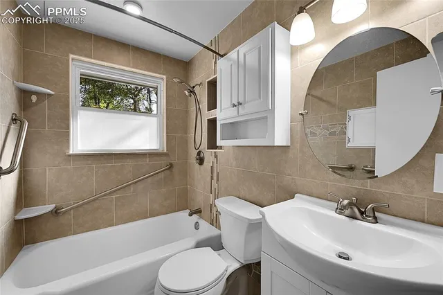 a bathroom with a sink a toilet and bathtub