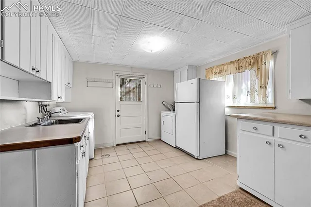 a kitchen with a sink cabinets and refrigerator