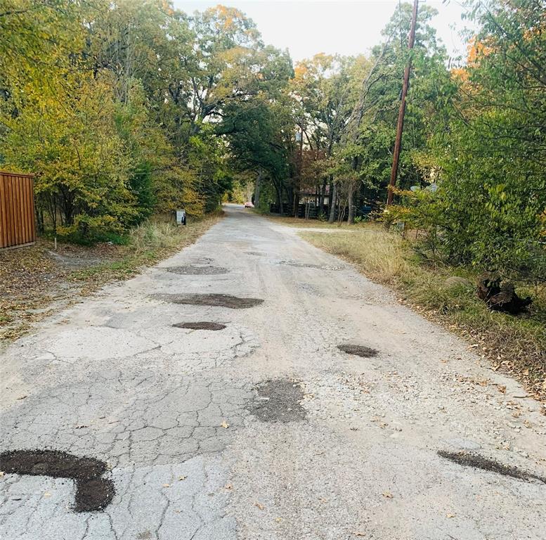 9744 Shady Lane Quinlan, TX 75474 - Photo 9 of 11 a view of a yard with trees and bushes