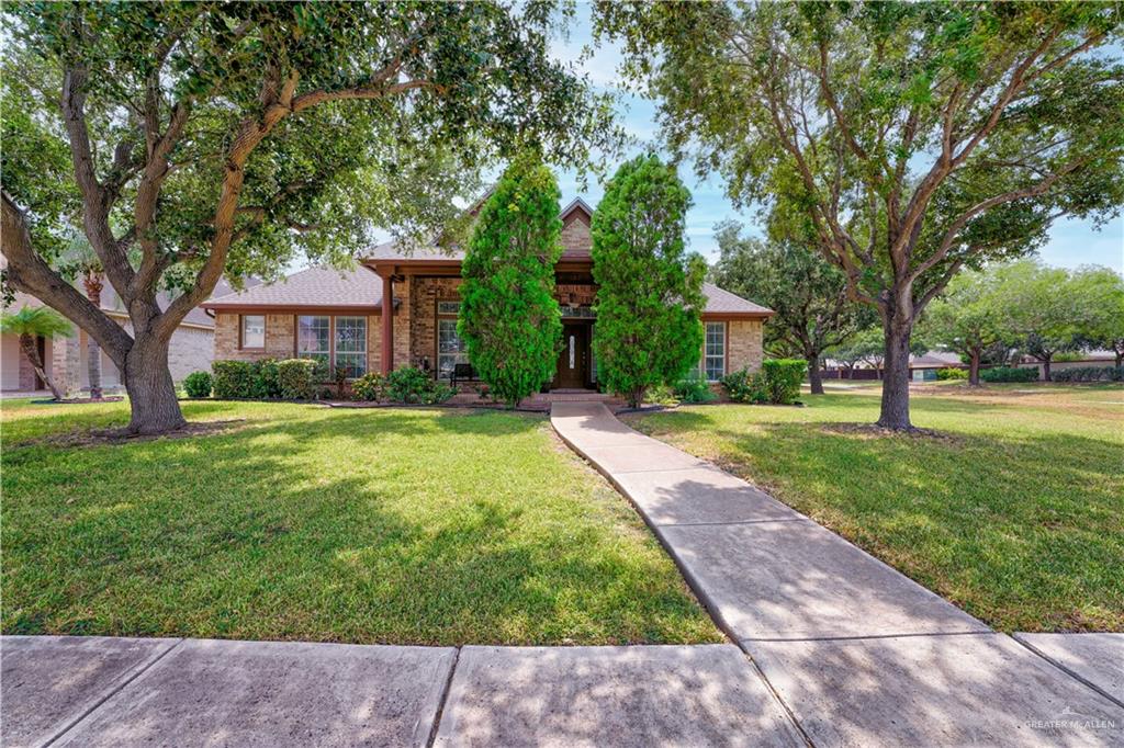 View of front of house with a front lawn and brick siding