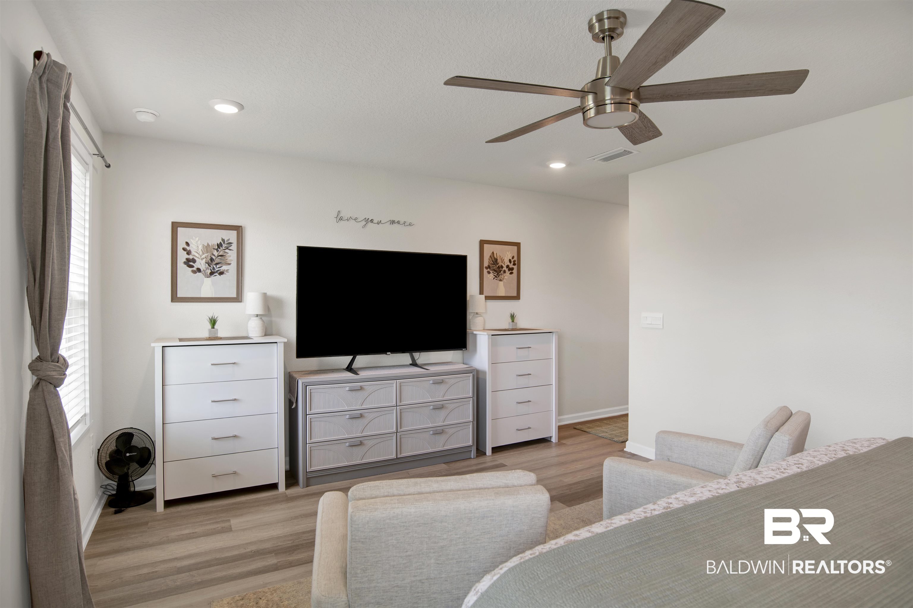 22301 Early Dawn Circle Foley, AL 36535 - Photo 18 of 45 Neutral toned interior featuring wood-finish flooring, recessed lighting, and a ceiling fan with brushed nickel hardware