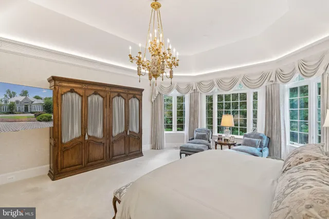 a bed room with a bed and a chandelier