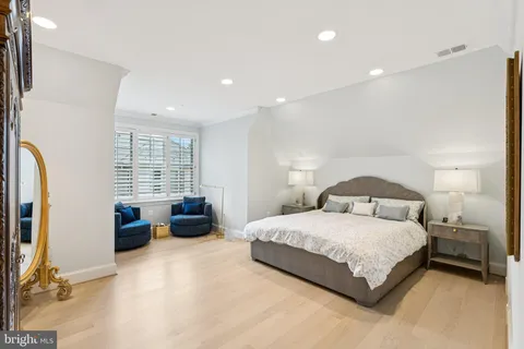 a bedroom with a bed and a couch