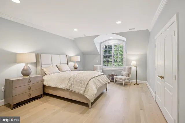 a bedroom with a large bed and window