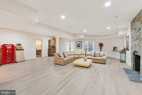 a living room with fireplace furniture and wooden floor