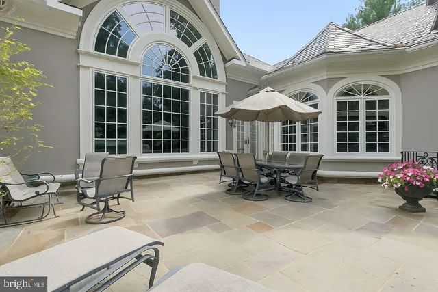 a building outdoor space with patio furniture and potted plants