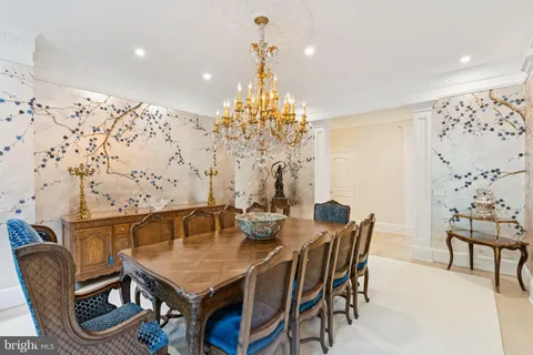 a view of a dining room with furniture and chandelier
