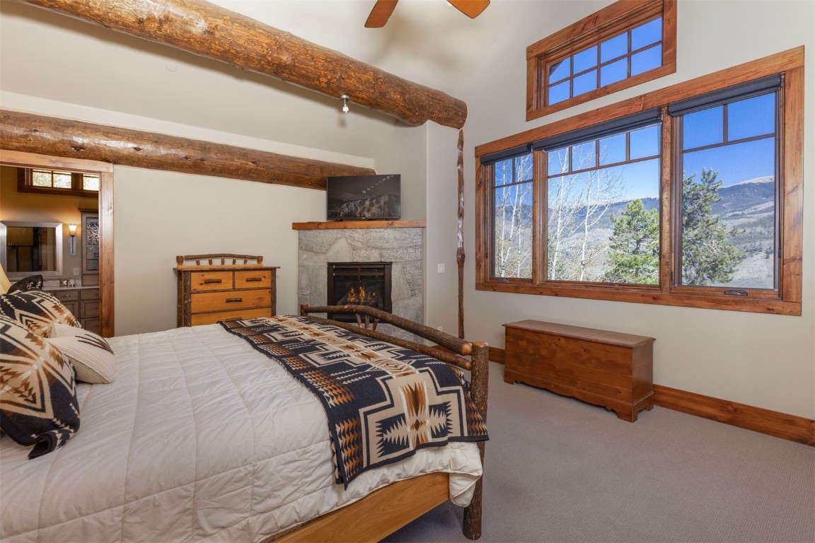 1330 Golden Eagle Road Silverthorne, CO 80498 - Photo 12 of 41 a spacious bedroom with a bed and a fireplace