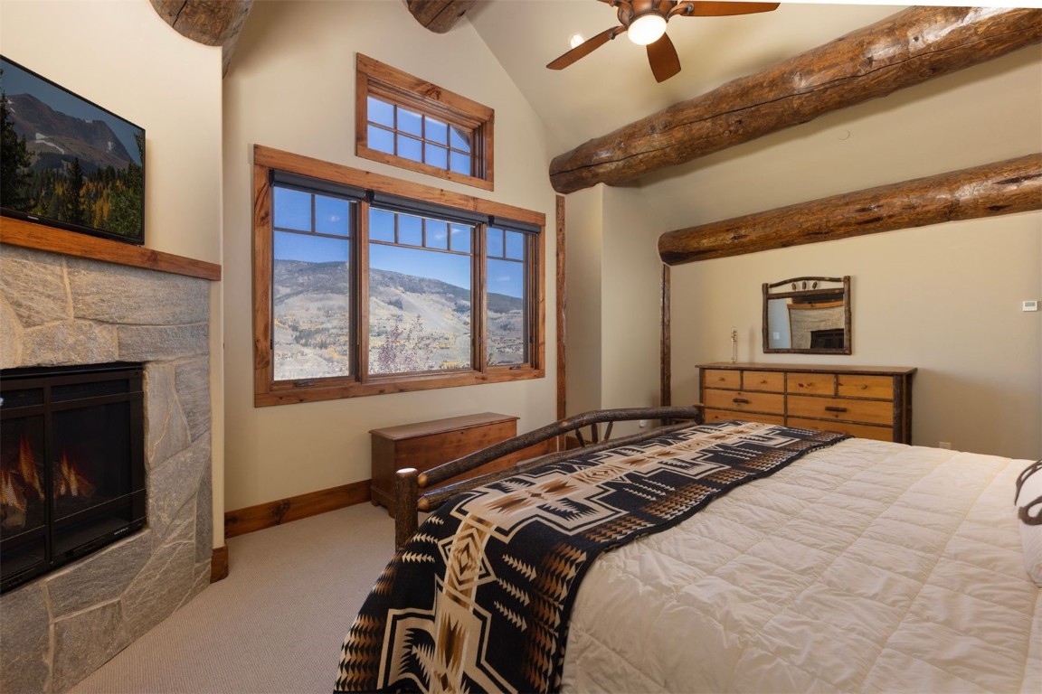 1330 Golden Eagle Road Silverthorne, CO 80498 - Photo 13 of 41 a bedroom with a bed and a fireplace