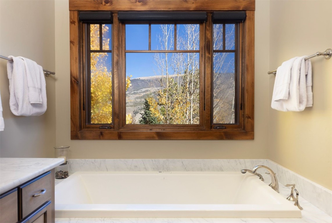 1330 Golden Eagle Road Silverthorne, CO 80498 - Photo 15 of 41 a bathroom with a bathtub and next to a window