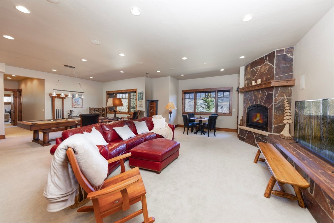 1330 Golden Eagle Road Silverthorne, CO 80498 - Photo 20 of 41 a living room with furniture a fireplace and a flat screen tv