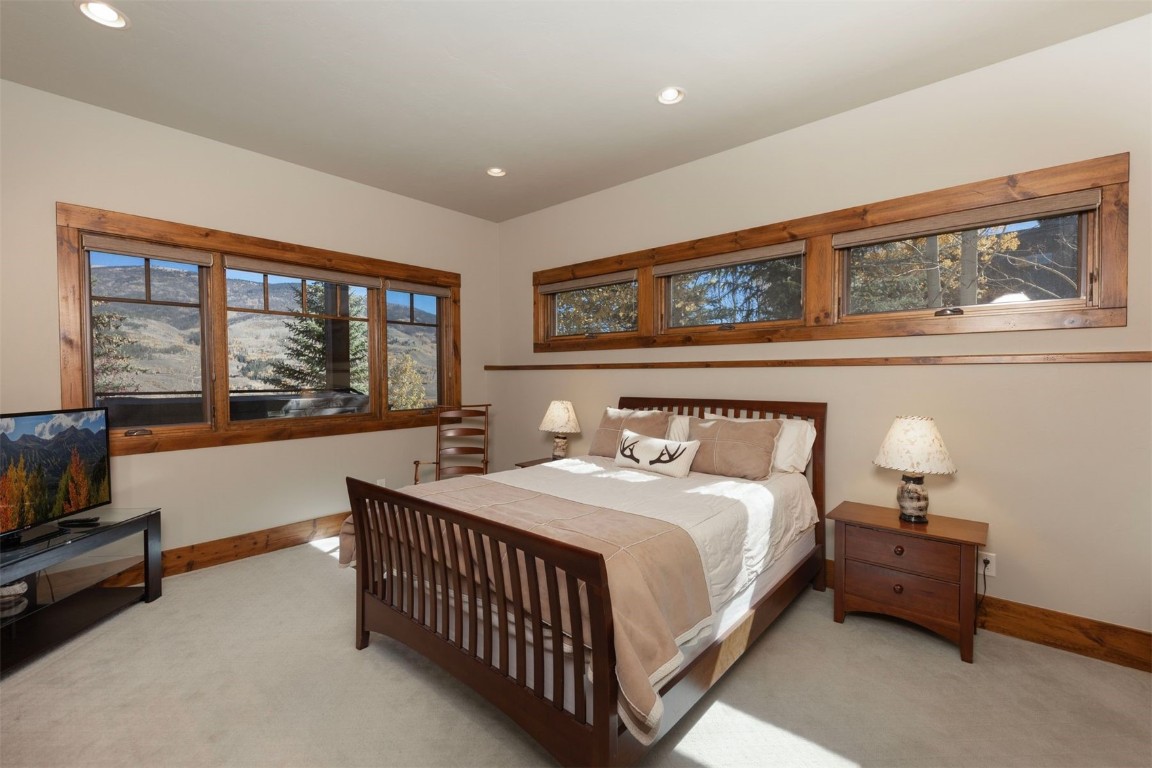 1330 Golden Eagle Road Silverthorne, CO 80498 - Photo 24 of 41 a bedroom with a bed and a large window