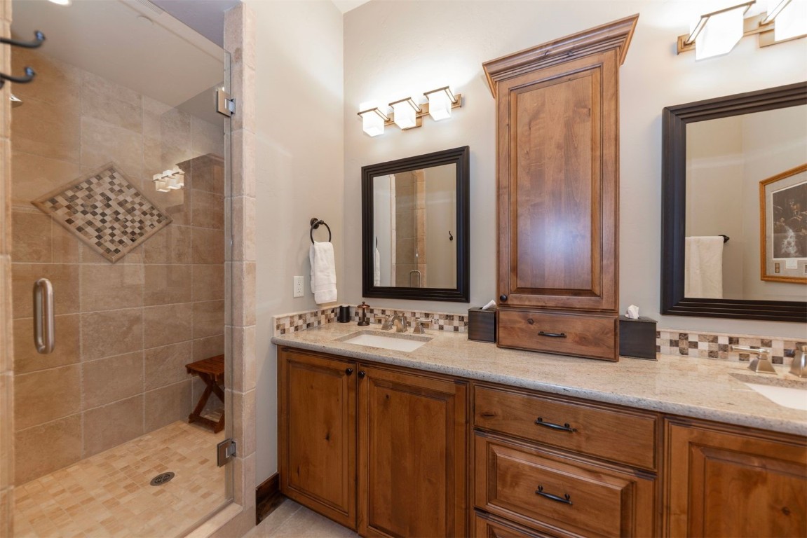 1330 Golden Eagle Road Silverthorne, CO 80498 - Photo 25 of 41 a bathroom with a double vanity sink mirror and shower