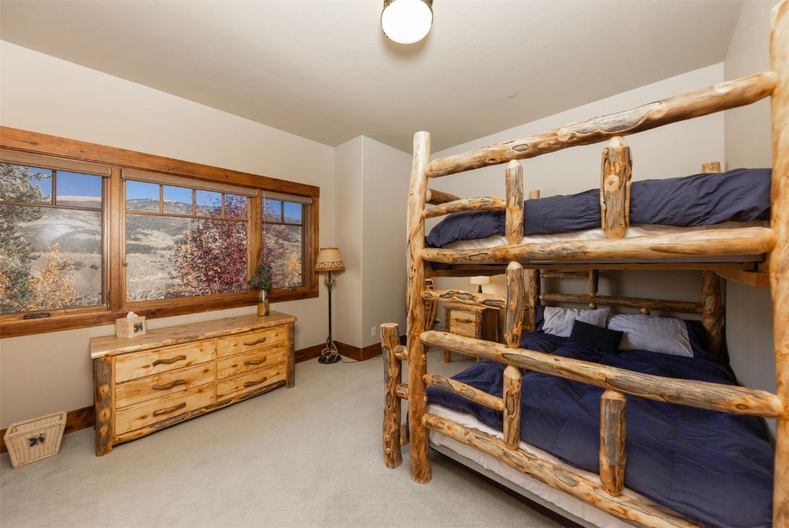 1330 Golden Eagle Road Silverthorne, CO 80498 - Photo 26 of 41 a bedroom with furniture and a large window