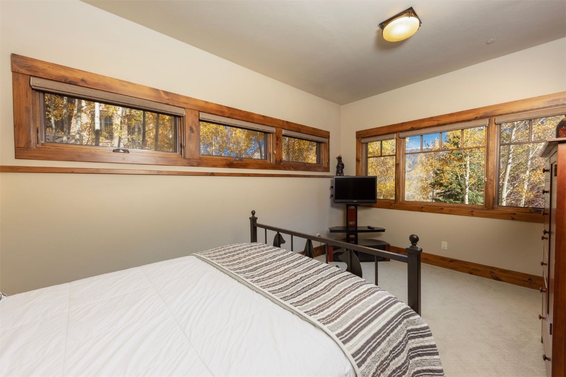 1330 Golden Eagle Road Silverthorne, CO 80498 - Photo 28 of 41 a bedroom with a bed and a window
