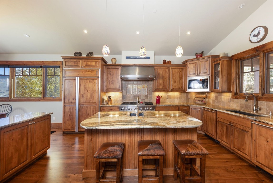 1330 Golden Eagle Road Silverthorne, CO 80498 - Photo 7 of 41 a large kitchen with a table and chairs