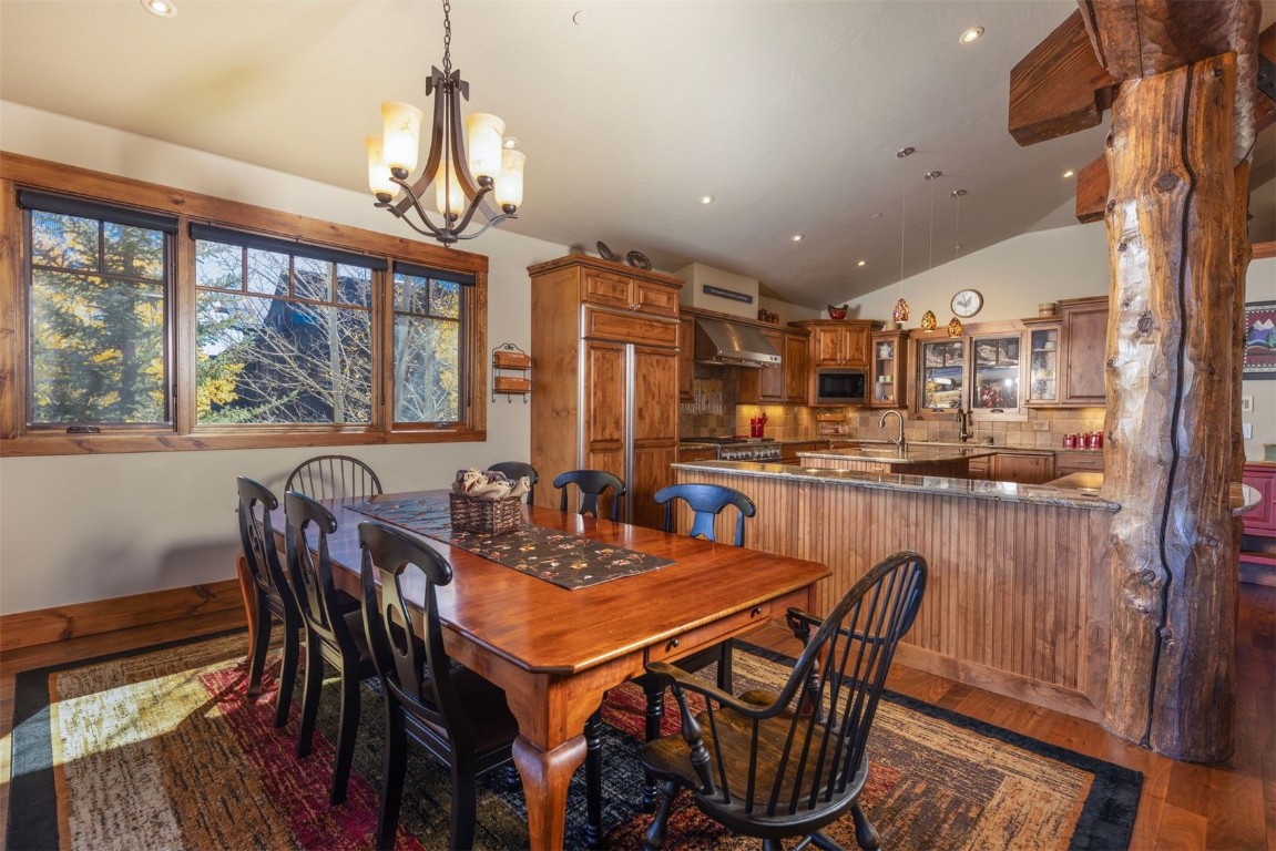 1330 Golden Eagle Road Silverthorne, CO 80498 - Photo 8 of 41 a dining room with furniture a chandelier and wooden floor