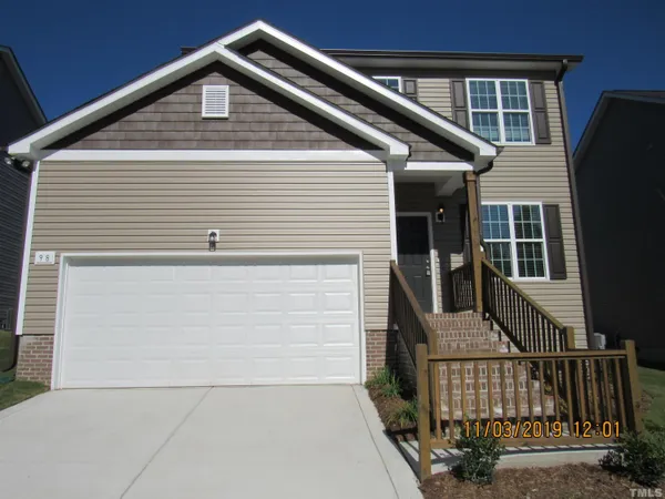 a front view of a house with garage