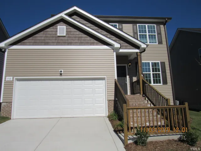 a front view of a house with garage