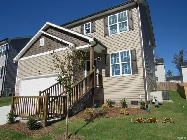 a view of house with backyard