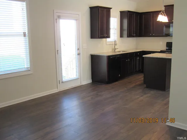 a kitchen with stainless steel appliances granite countertop a sink and a stove