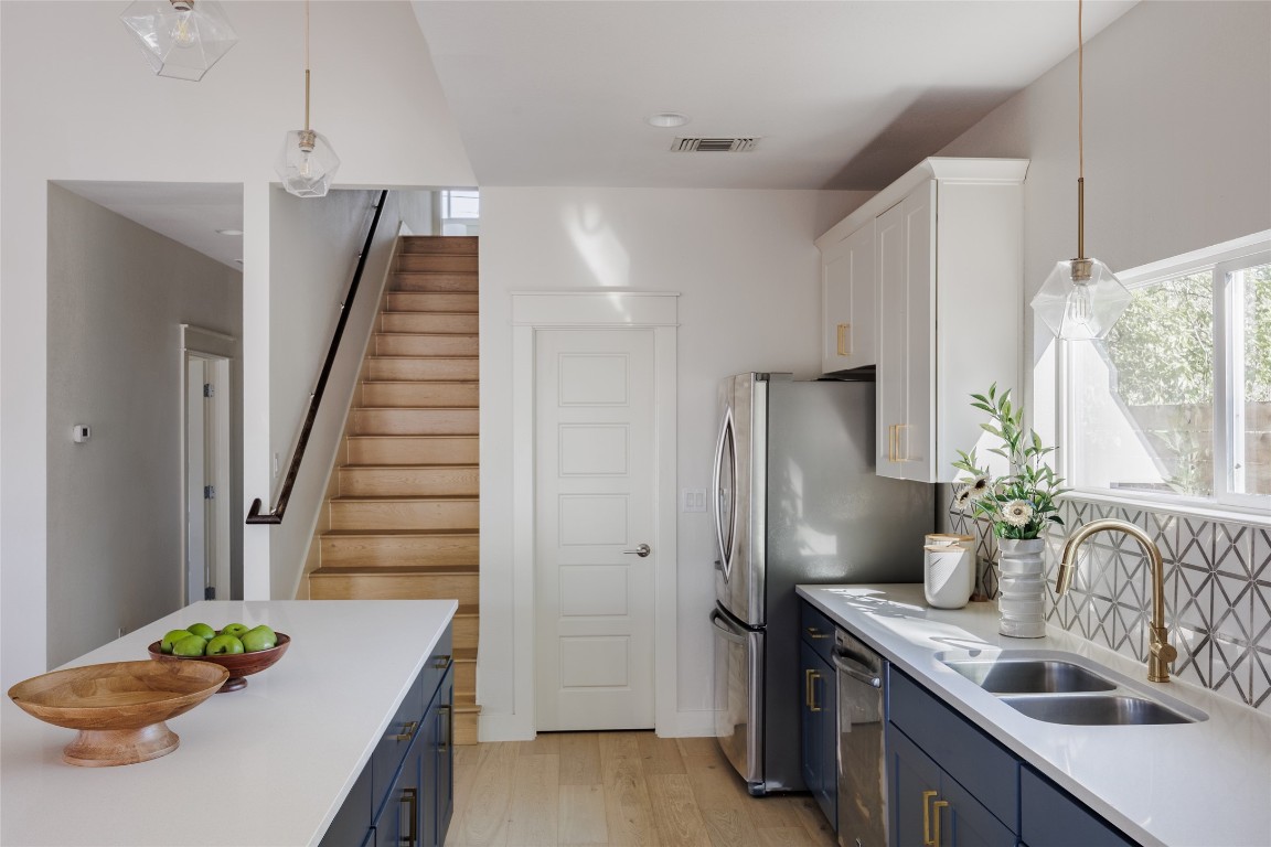 1205 McKinley Avenue Austin, TX 78702 - Photo 12 of 34 a kitchen with stainless steel appliances granite countertop a sink refrigerator and microwave