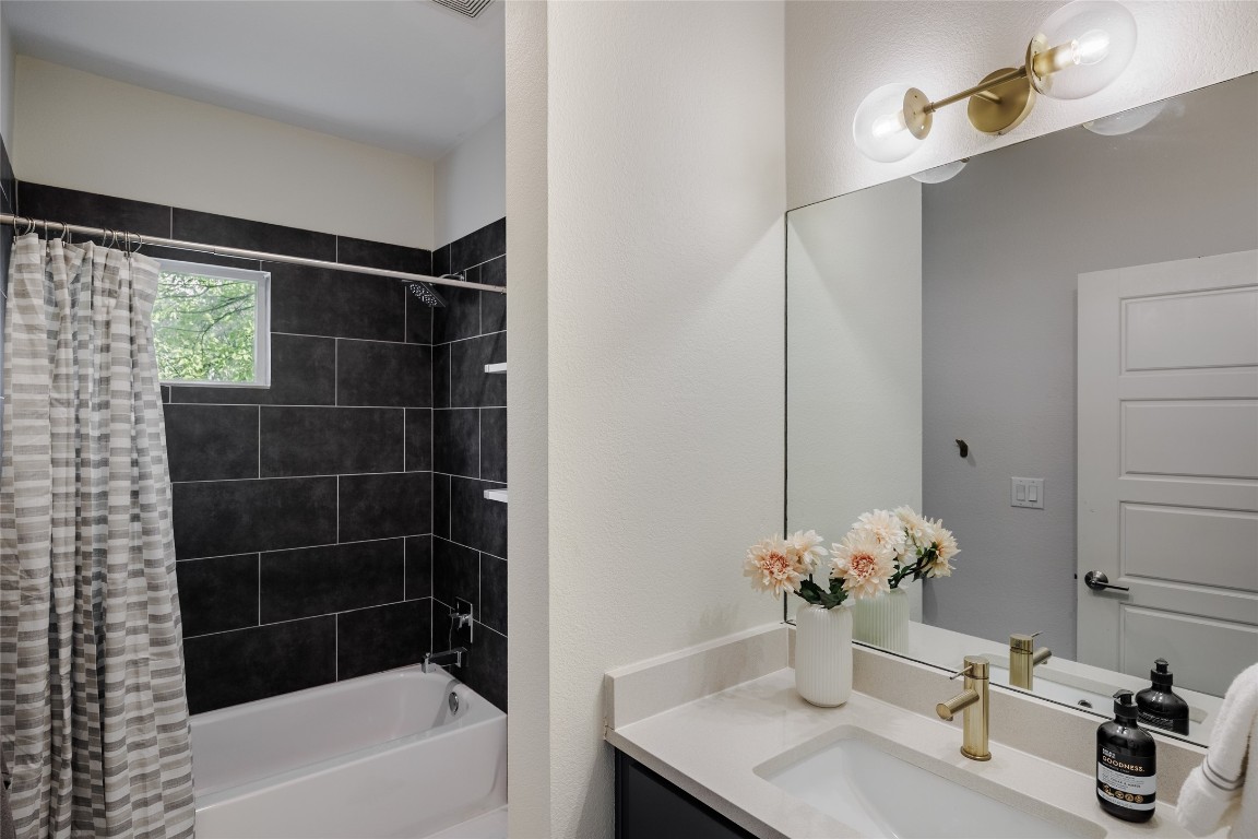 1205 McKinley Avenue Austin, TX 78702 - Photo 18 of 34 a bathroom with a tub shower vanity and a sink