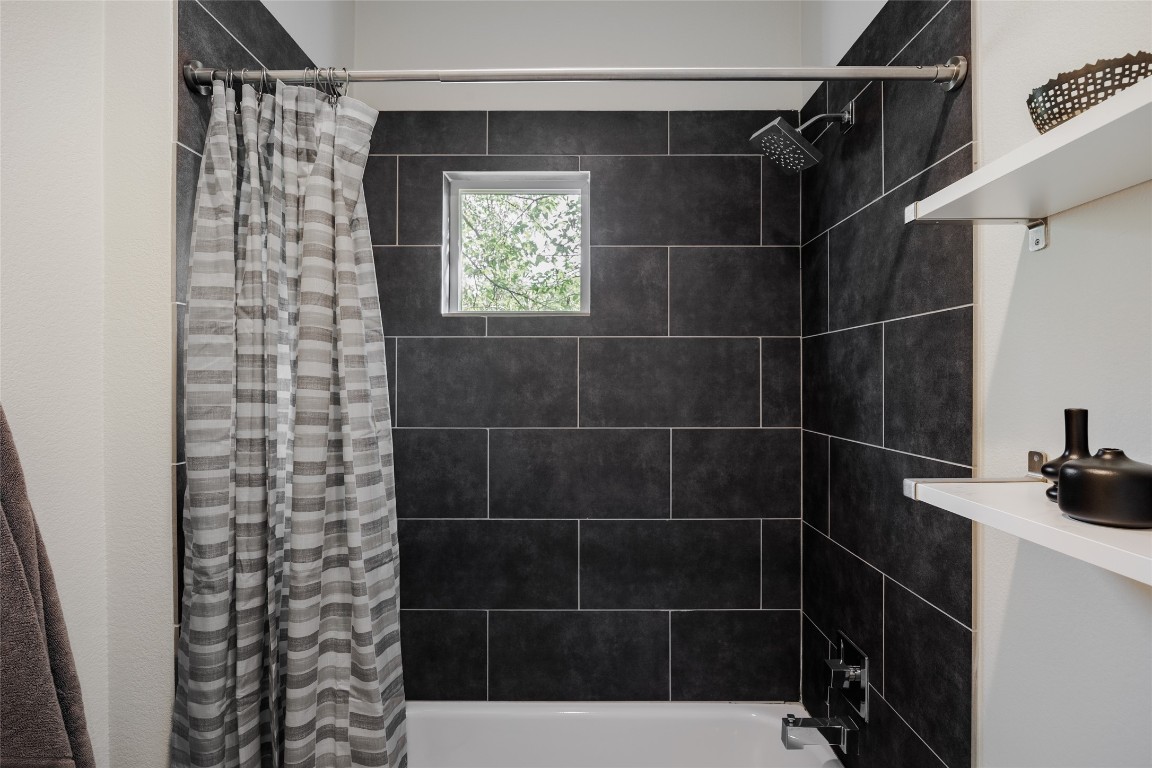 1205 McKinley Avenue Austin, TX 78702 - Photo 19 of 34 a bathroom with a bathtub and shower