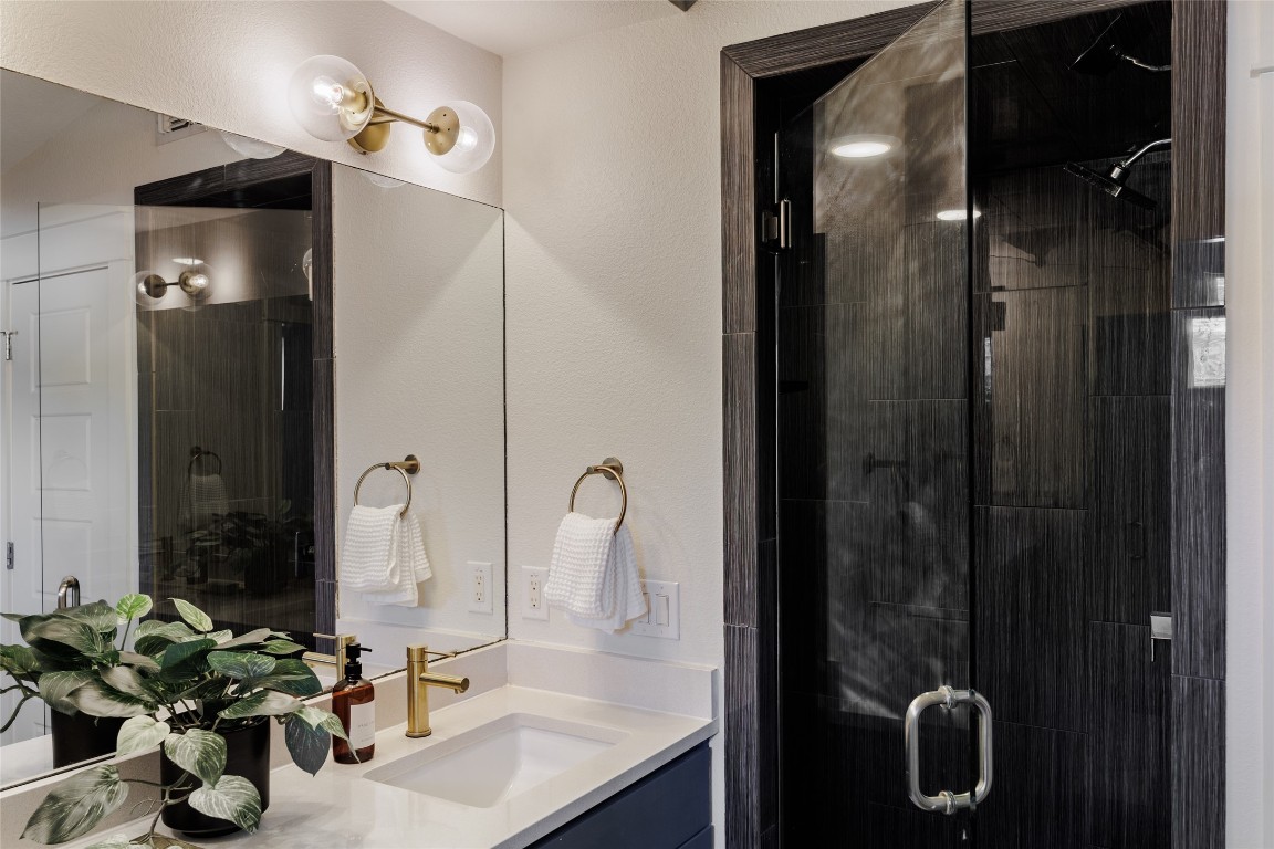 1205 McKinley Avenue Austin, TX 78702 - Photo 24 of 34 a bathroom with a sink vanity and a mirror