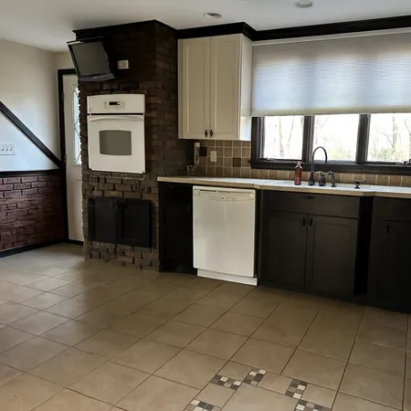 a kitchen with a sink cabinets and appliances