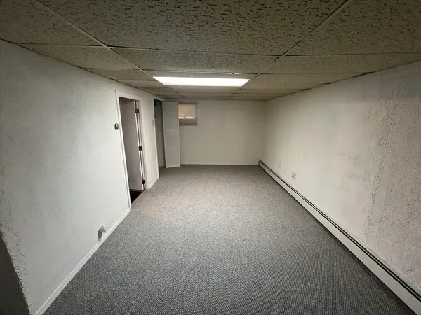 an empty room with a empty space and windows