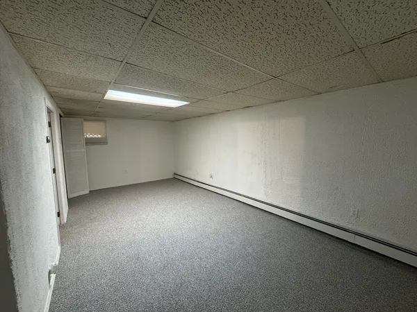 an empty room with a empty space and windows