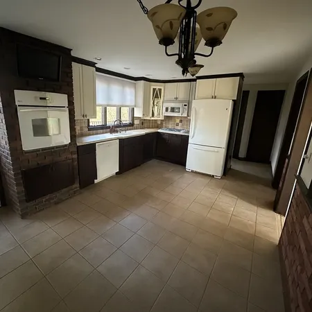 a kitchen with refrigerator and cabinets