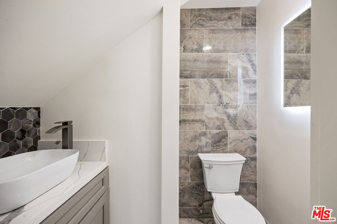 1342 Mohawk Street Los Angeles, CA 90026 - Photo 18 of 29 a white toilet sitting next to a bathroom sink