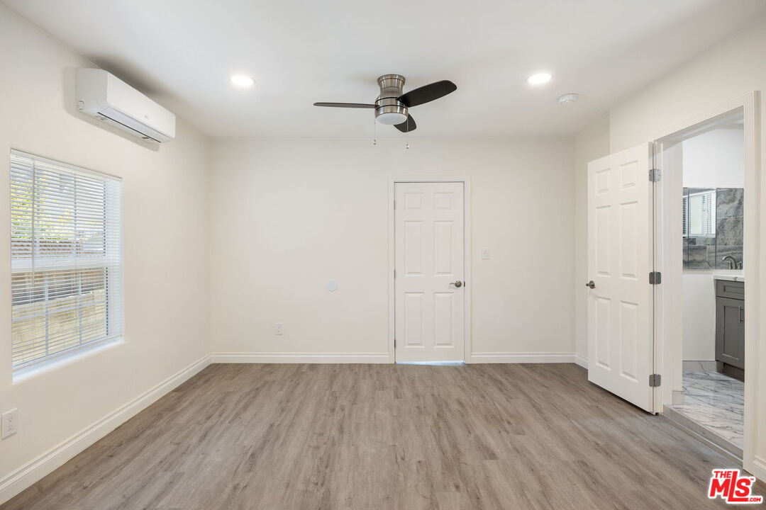 1342 Mohawk Street Los Angeles, CA 90026 - Photo 20 of 29 an empty room with wooden floor a ceiling fan and windows