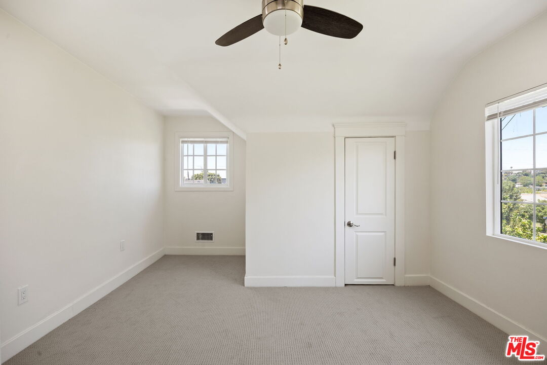 1342 Mohawk Street Los Angeles, CA 90026 - Photo 22 of 29 an empty room with windows and ceiling fan