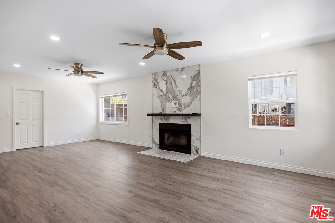 1342 Mohawk Street Los Angeles, CA 90026 - Photo 7 of 29 wooden floor fireplace and windows in an empty room