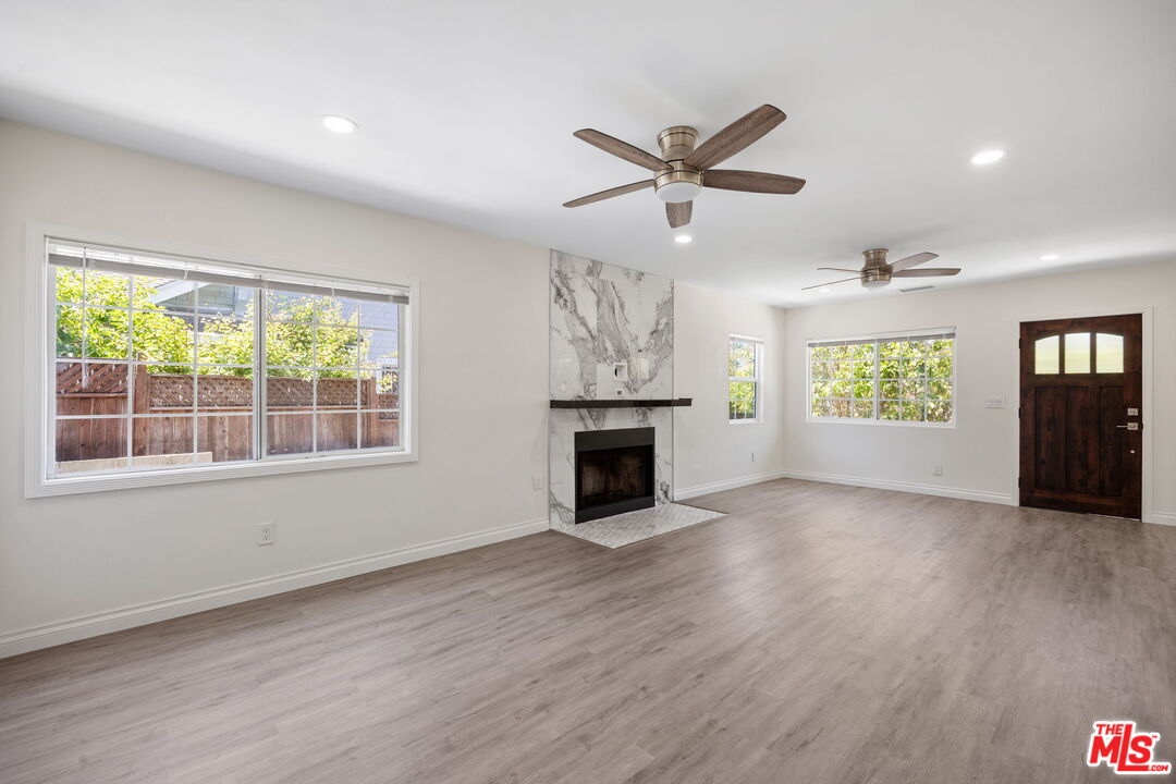 1342 Mohawk Street Los Angeles, CA 90026 - Photo 8 of 29 an empty room with windows and fireplace