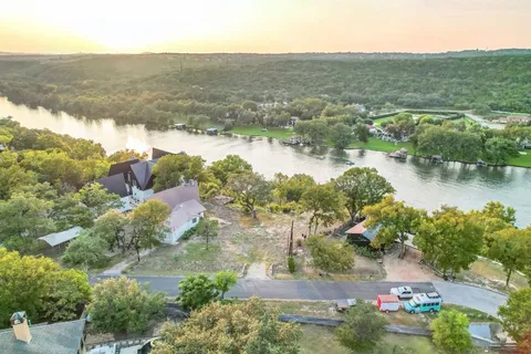 an aerial view of residential houses with outdoor space and river