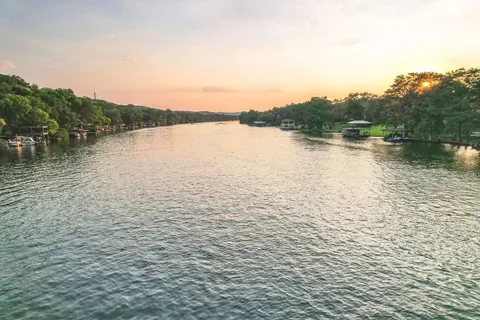 a view of a field with trees in the background