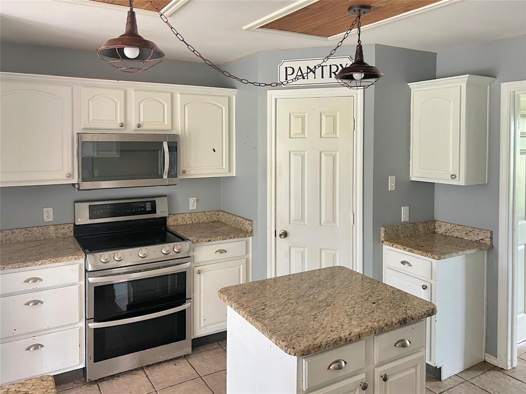 3661 Emo Street Midlothian, TX 76065 - Photo 6 of 24 a kitchen with granite countertop a sink stainless steel appliances and cabinets