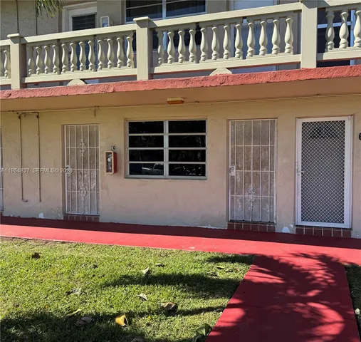 a view of a house with a small yard