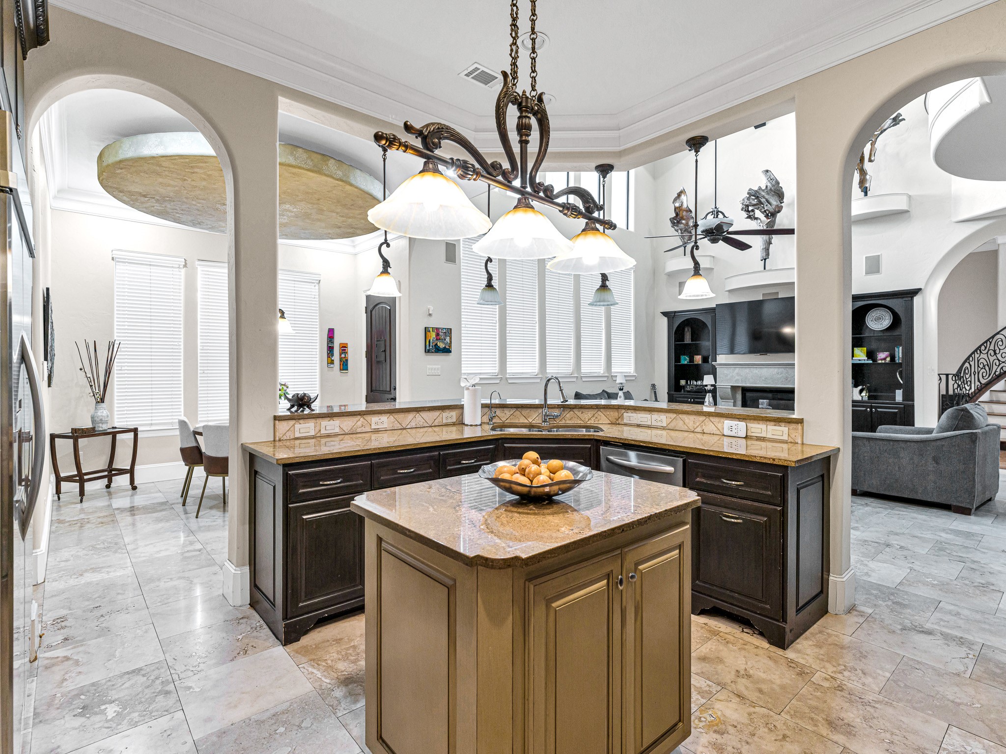 4614 Inker Street Houston, TX 77007 - Photo 15 of 36 This spacious, open-concept kitchen features a large central island with granite countertops, and stylish pendant lighting. It seamlessly connects to the living area, providing a perfect space for entertaining.